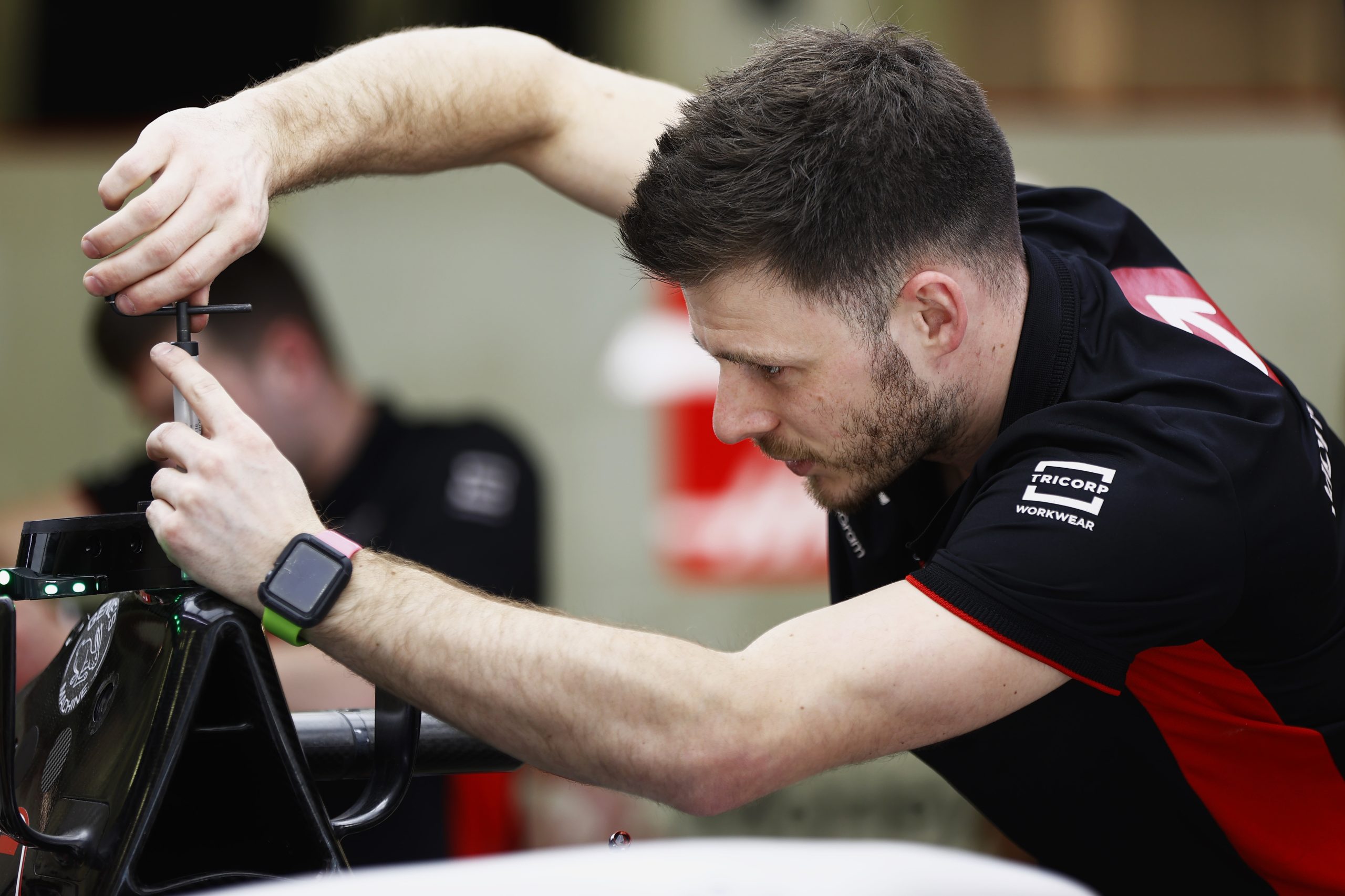 BAHRAIN INTERNATIONAL CIRCUIT, BAHRAIN - MARCH 02: A Haas F1 Team mechanic at work in the garage during the Bahrain GP at Bahrain International Circuit on Thursday March 02, 2023 in Sakhir, Bahrain. (Photo by Andy Hone / LAT Images)